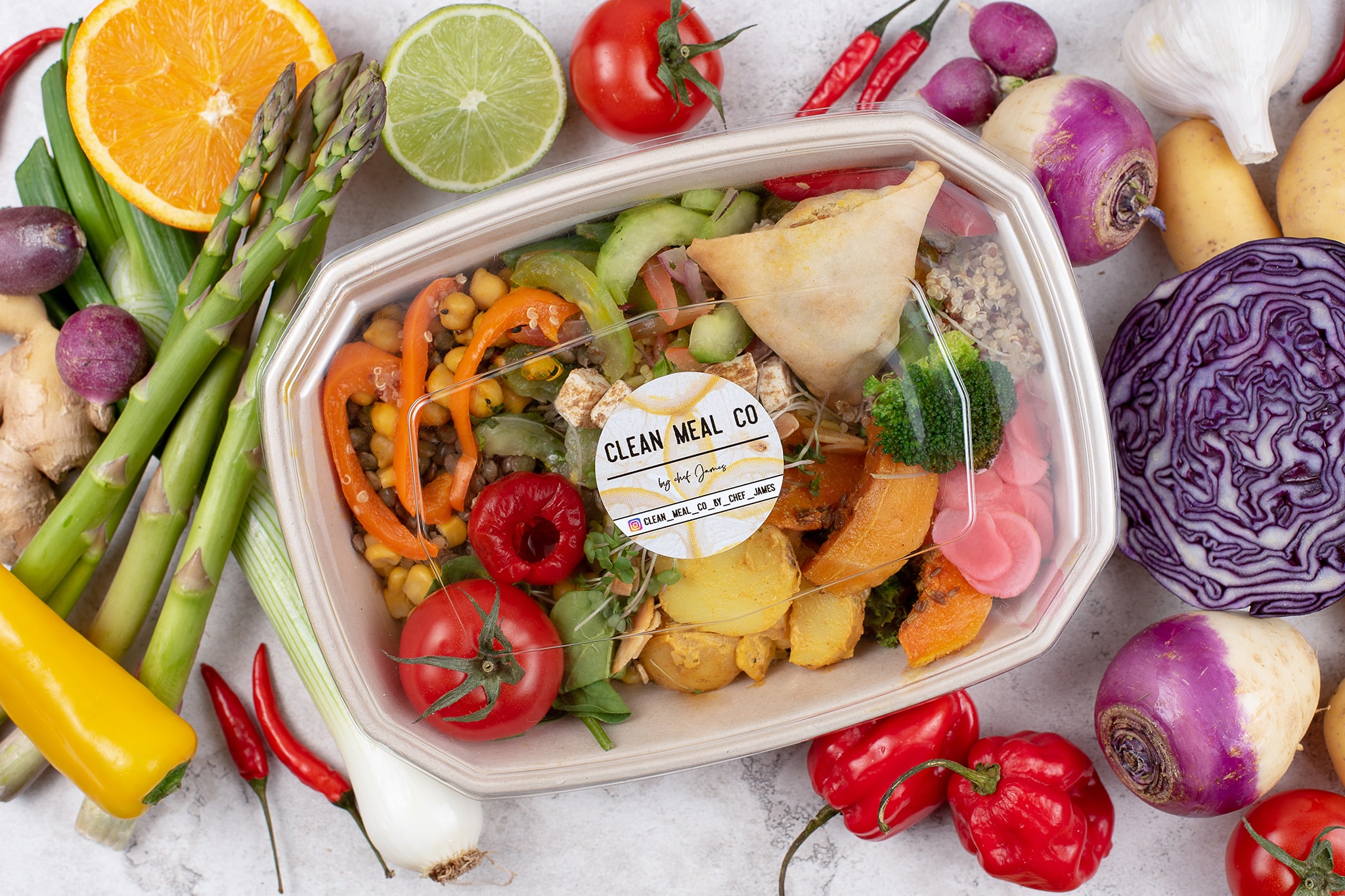 Clean Meal Company colourful food box and mixed salad on marble worktop